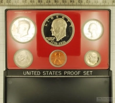 1975 US coin proof set sealed in hard plastic with a red matte background