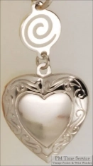 Silver-toned heart shaped locket with delicate engraving & round connector with a swirl design